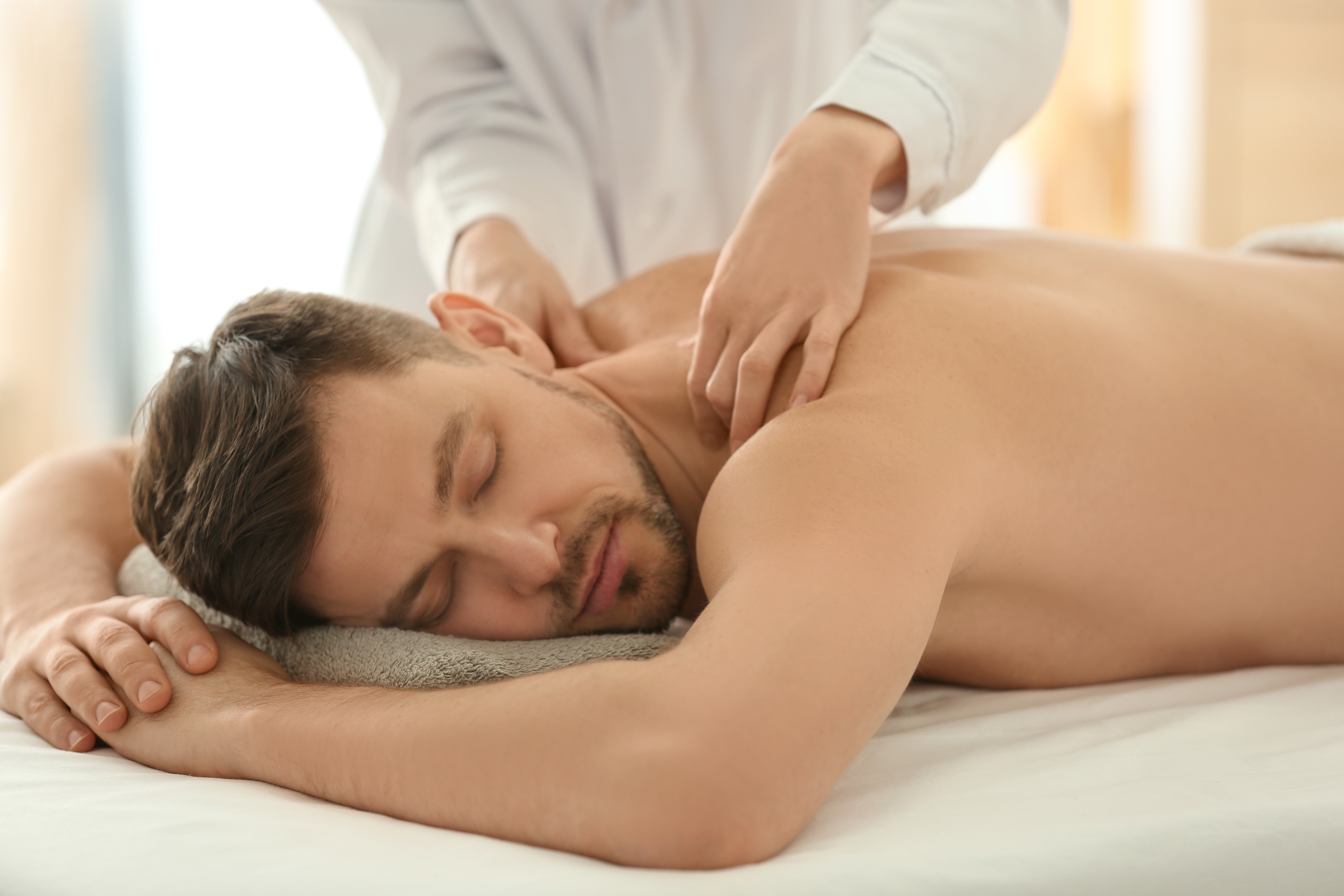 Mens back, face, scalp treatment with hot stones